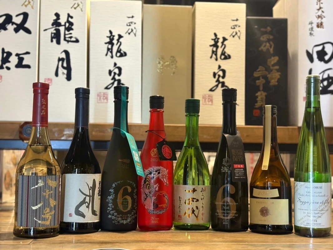 Various sake and wine bottles on a shelf