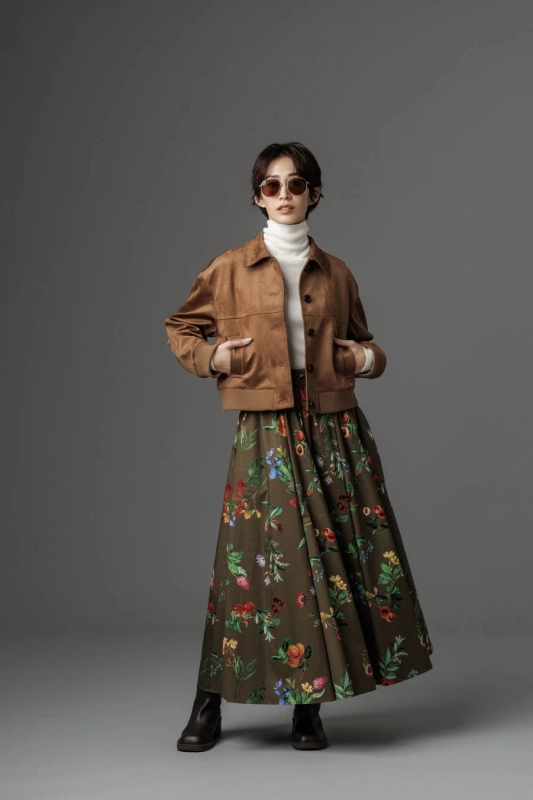 Model in a brown jacket and floral wide pants