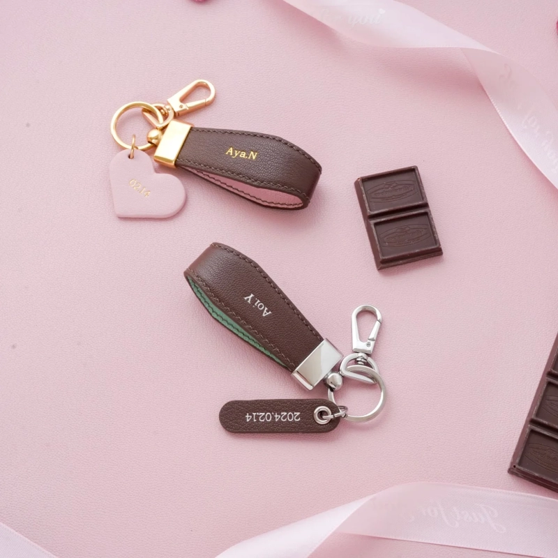 Named leather keyholders, chocolate, pink background