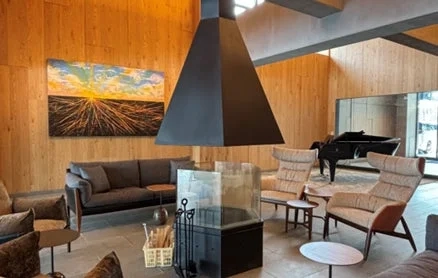 Elegant lounge with a modern fireplace and grand piano