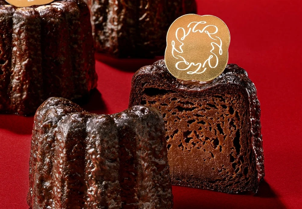 Cut Canelé revealing rich chocolate interior