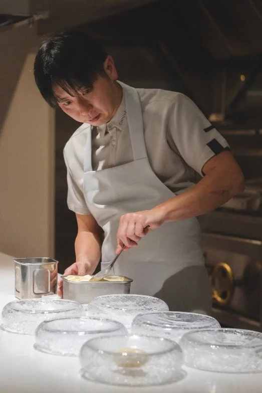 Chef Satoshi Furuta meticulously plating a dish