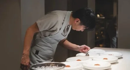 Chef meticulously plating a dish