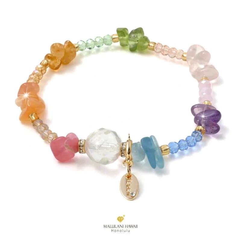 A colorful power stone bracelet with a golden charm, on a white background.