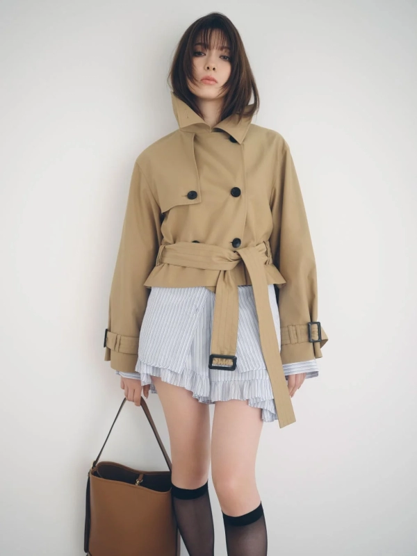 Arisa Yagi in a short beige trench coat and striped ruffled shirt