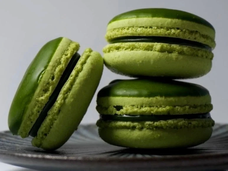 Three stacked green macarons
