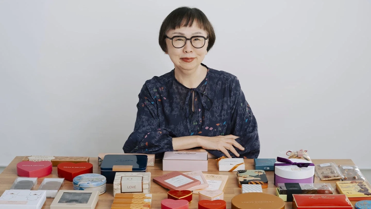 Rika Fukuda smiling amidst a display of DEAN & DELUCA chocolate collections