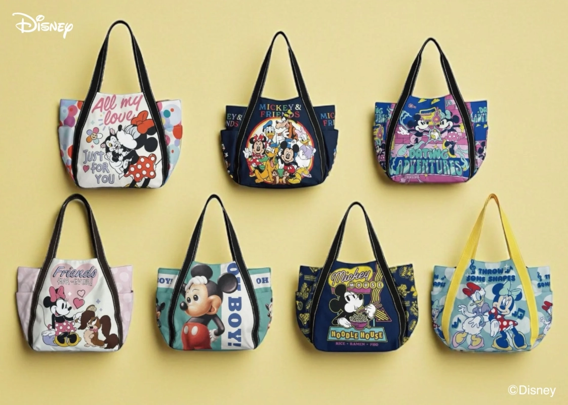 Seven different Disney character balloon tote bags on a yellow background