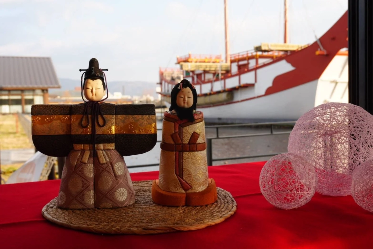 Hina Dolls near a Traditional Boat
