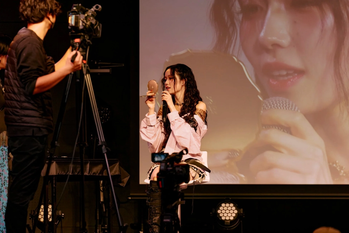 MYERA member checking lipstick in mirror