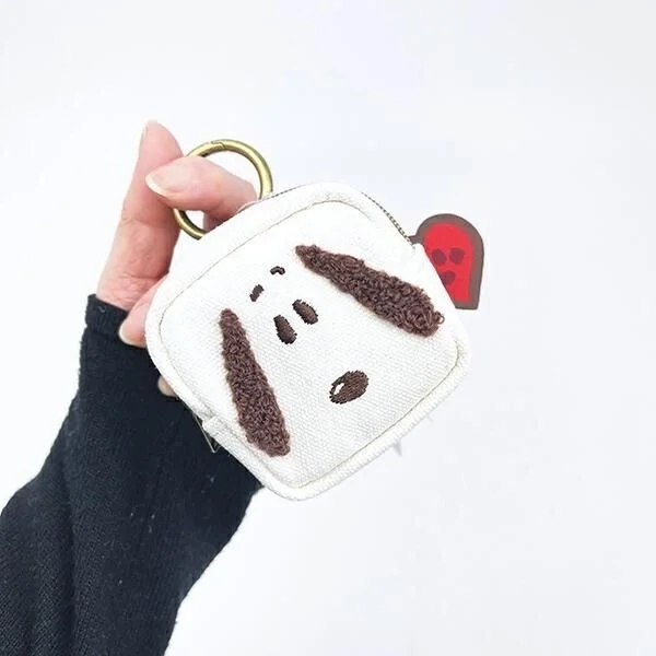 Hand holding carabiner mini pouch