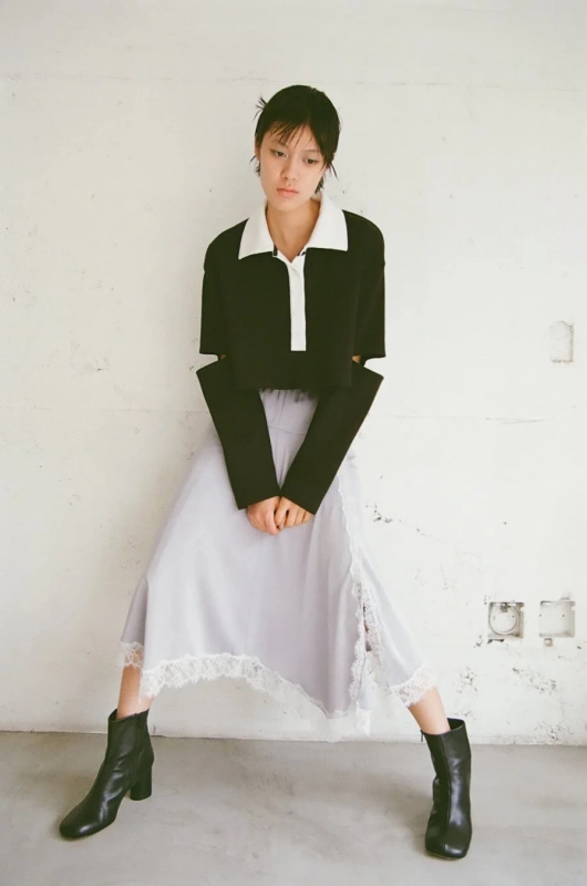 Black cropped top, lace-trim skirt, boots