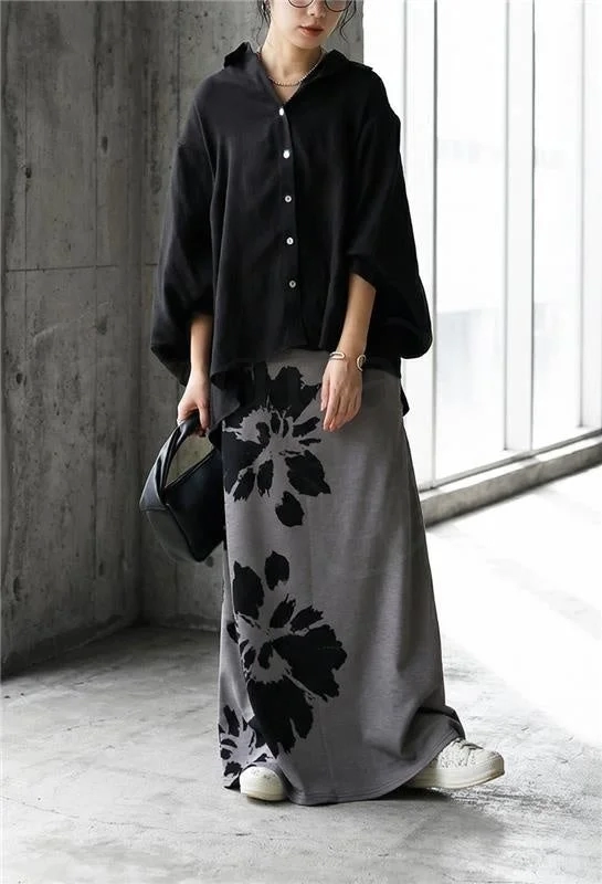 A model showcasing the skirt's flowing A-line silhouette, paired with an oversized black shirt.
