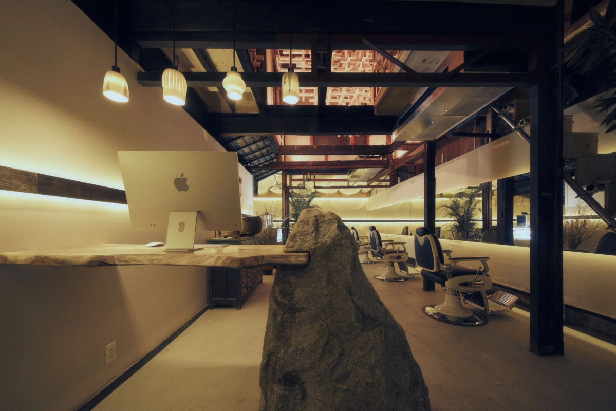 Reception with Aji stone counter, Mac, barber chair