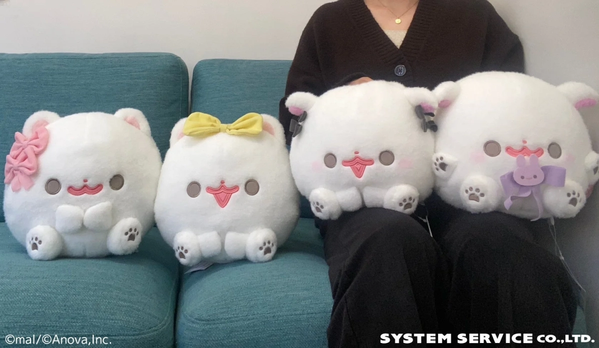 Pomeranian Mochi Plushies on a Turquoise Sofa