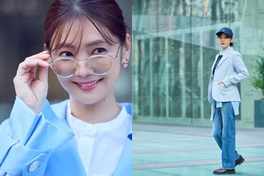 A smiling woman in glasses and another in a blue jacket, jeans, and a cap outdoors.