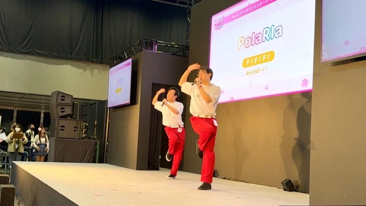 Fan groups performing on stage