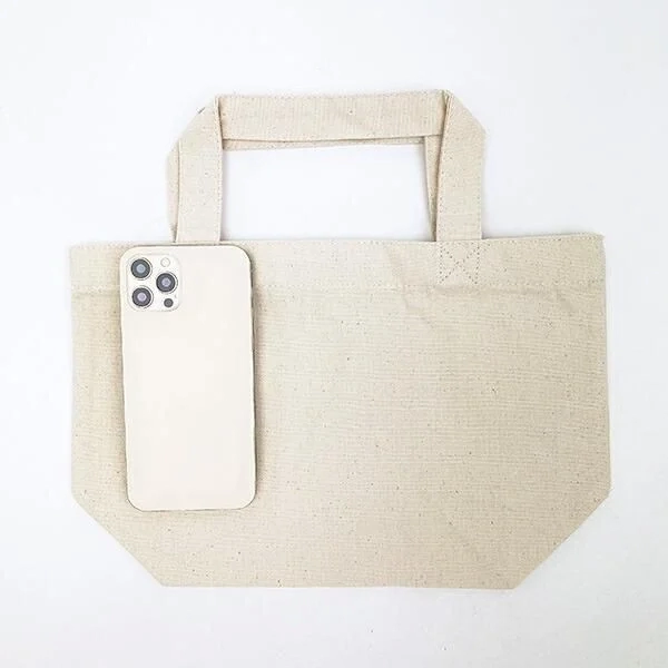 Plain canvas tote bag with a smartphone for size comparison