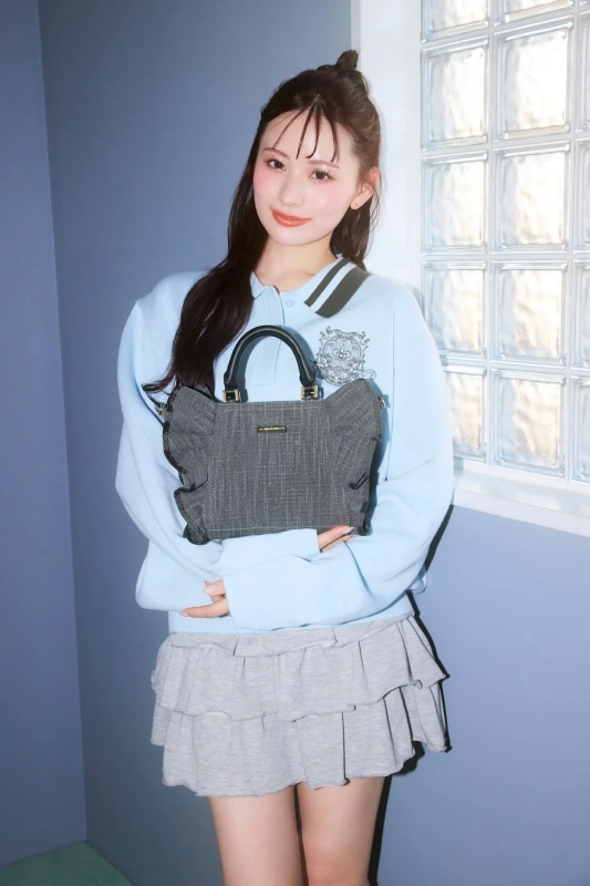 Kotomi Tachibana with a fringe handbag, standing