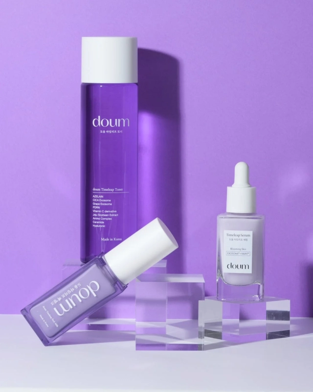 doum Timeleap skincare products on acrylic stands