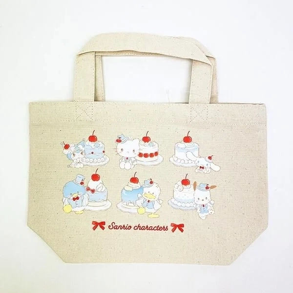 Sanrio characters on a light-colored tote bag with blue cherry cake