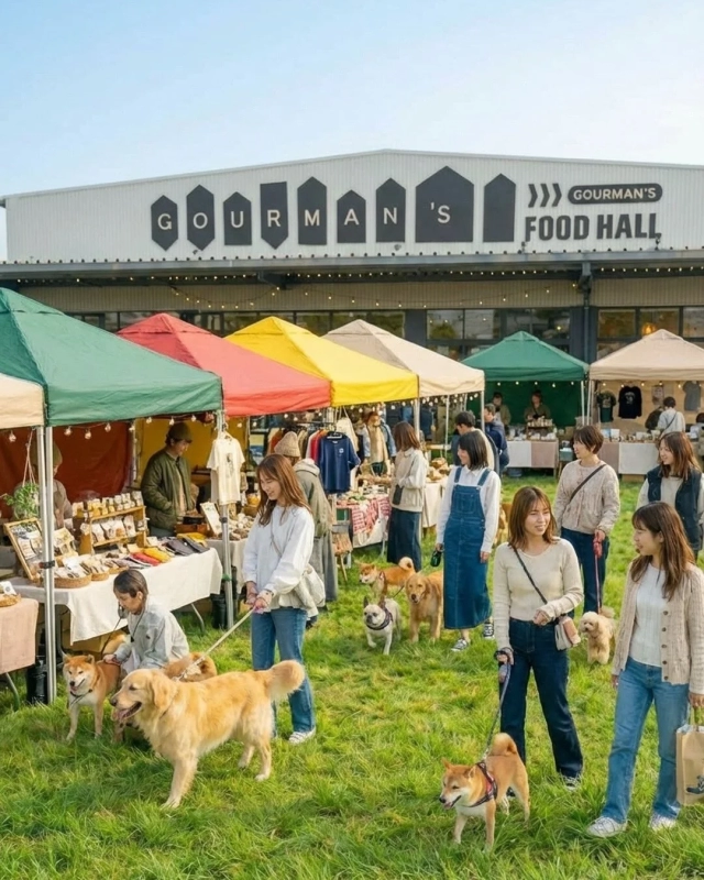 A bustling outdoor market scene with many people and their dogs, under colorful tents.