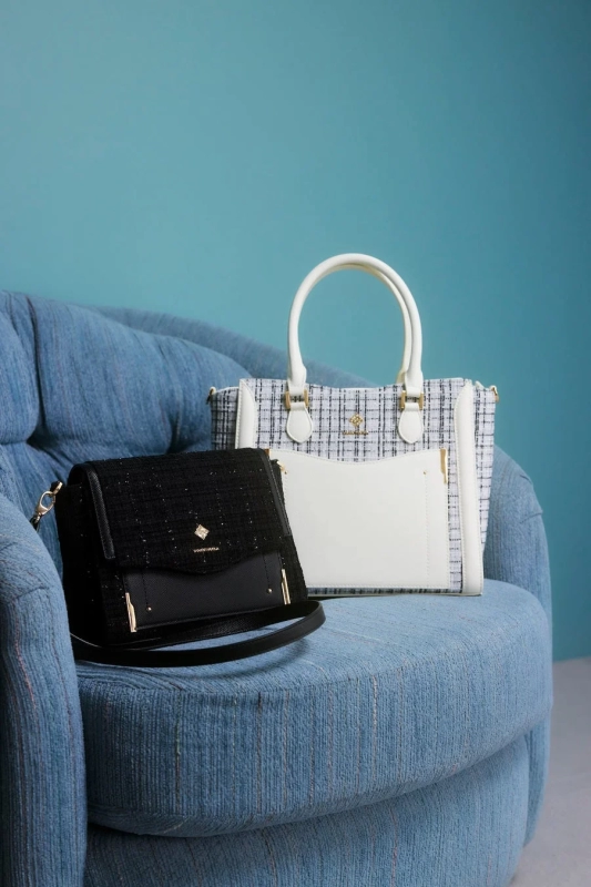 Tweed Samantha Vega bags on a blue sofa