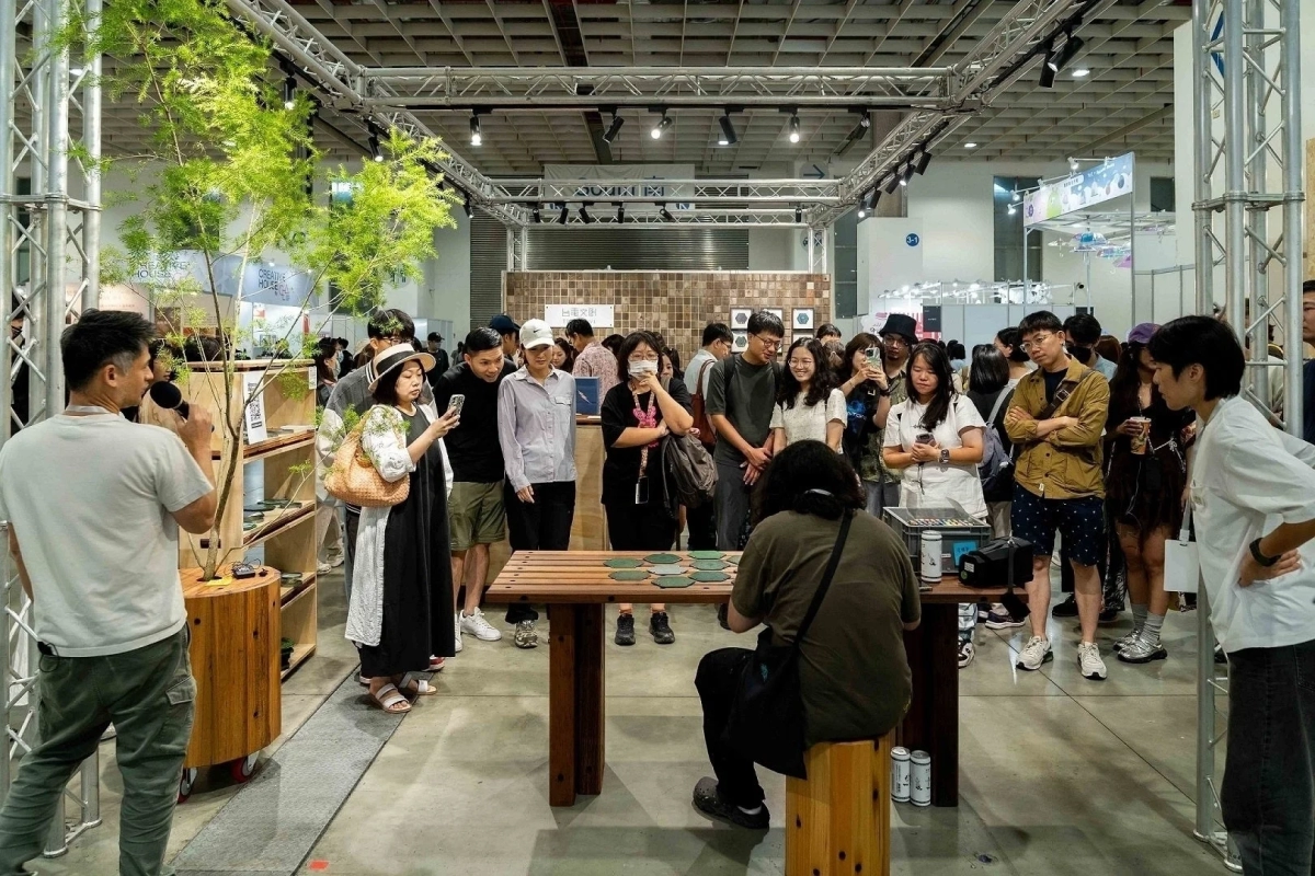 People engaging at an exhibition booth