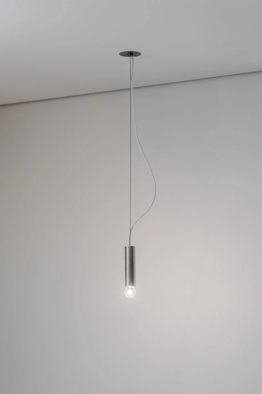 A simple, cylindrical pendant light illuminated