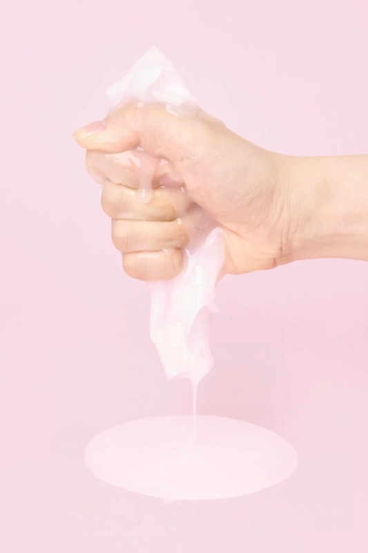 Hand squeezing essence from Numbuzin sheet mask