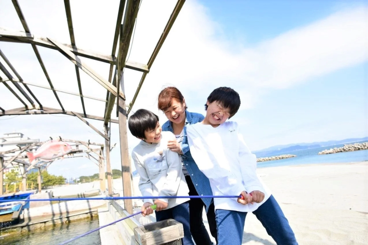 Family fishing by the sea