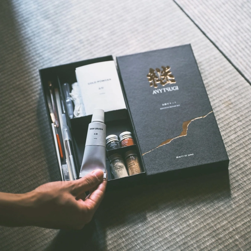 Hand taking lacquer from Kintsugi kit