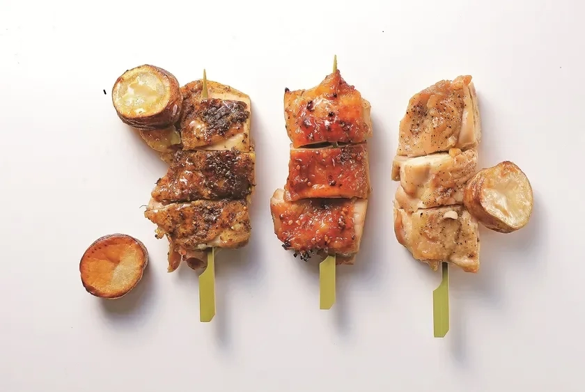 Three different roast chicken skewers with small potatoes