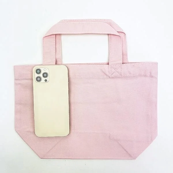 Light pink mini tote bag with an iPhone for size comparison