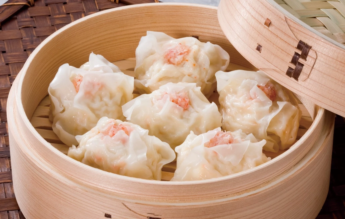 Delicious shumai dumplings neatly arranged in a bamboo steamer, ready to be enjoyed.