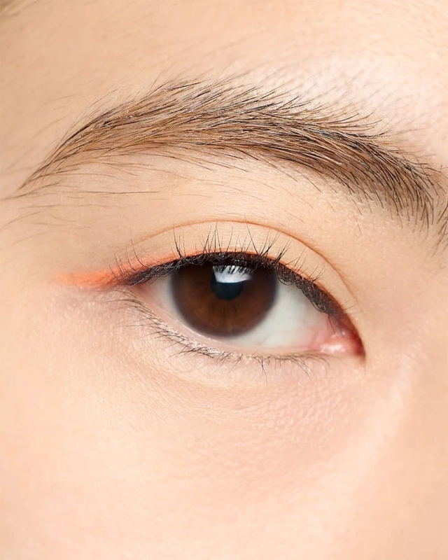 Eye with orange eyeliner