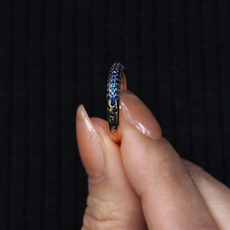 Hand holding a sapphire ring