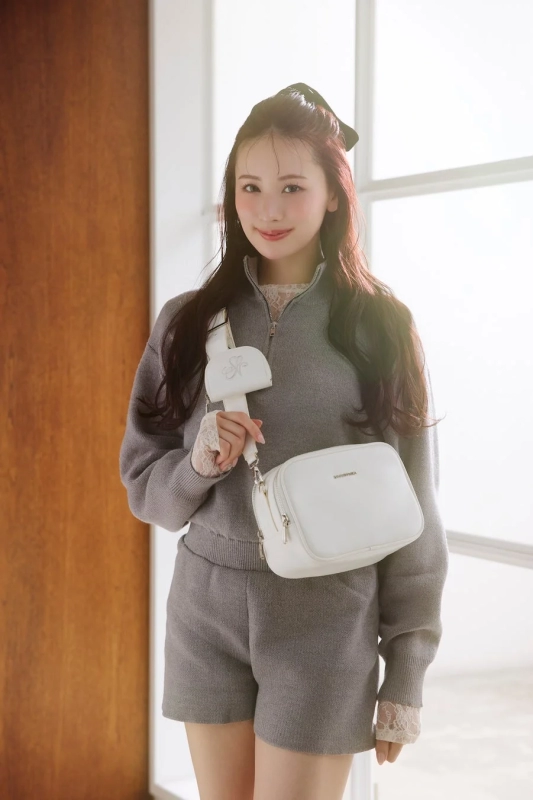 Kotomi Tachibana showcasing a white shoulder bag from the Travel Collection