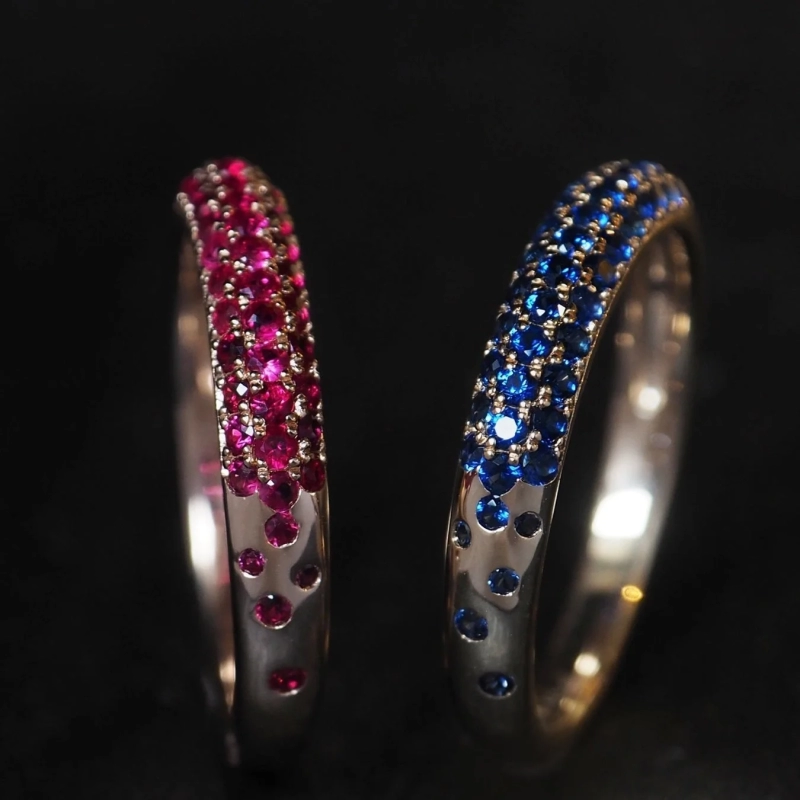 Two rings with pink and blue gemstones