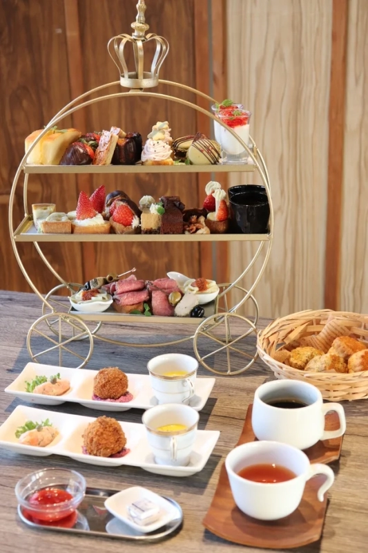 Afternoon tea set with strawberry tarts and roast beef