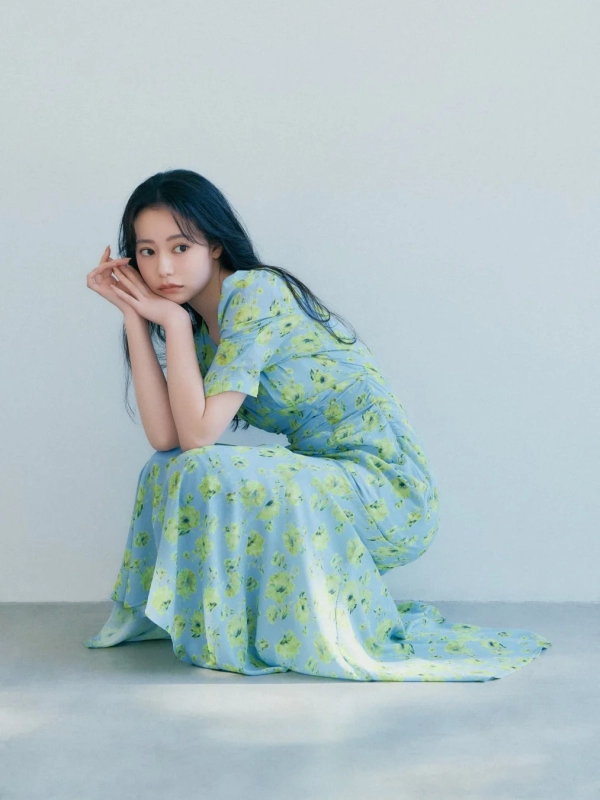 Model in blue floral dress